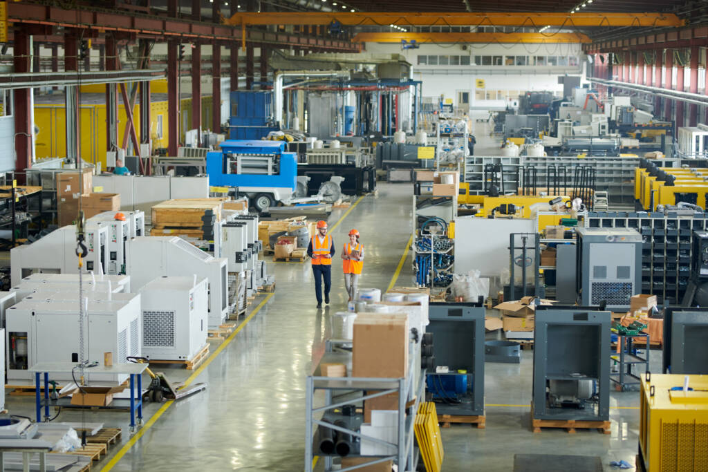 2 workers walking through warehouse