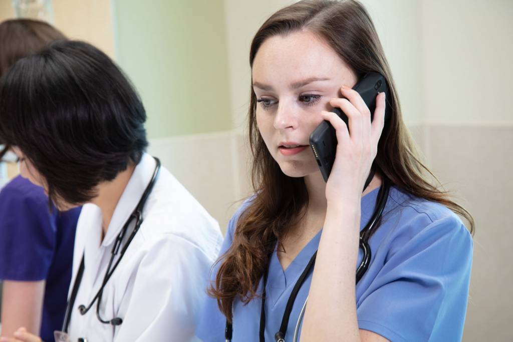 healthcare worker talking on a smartphone