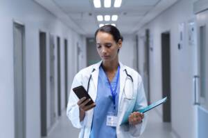 Healthcare worker in hallway using Spectralink mobile device