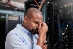 frustrated IT tech emphasizing the case for centralized device management