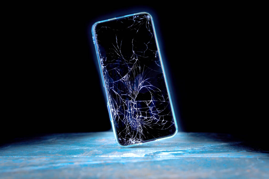 Closeup of mobile device with cracked screen