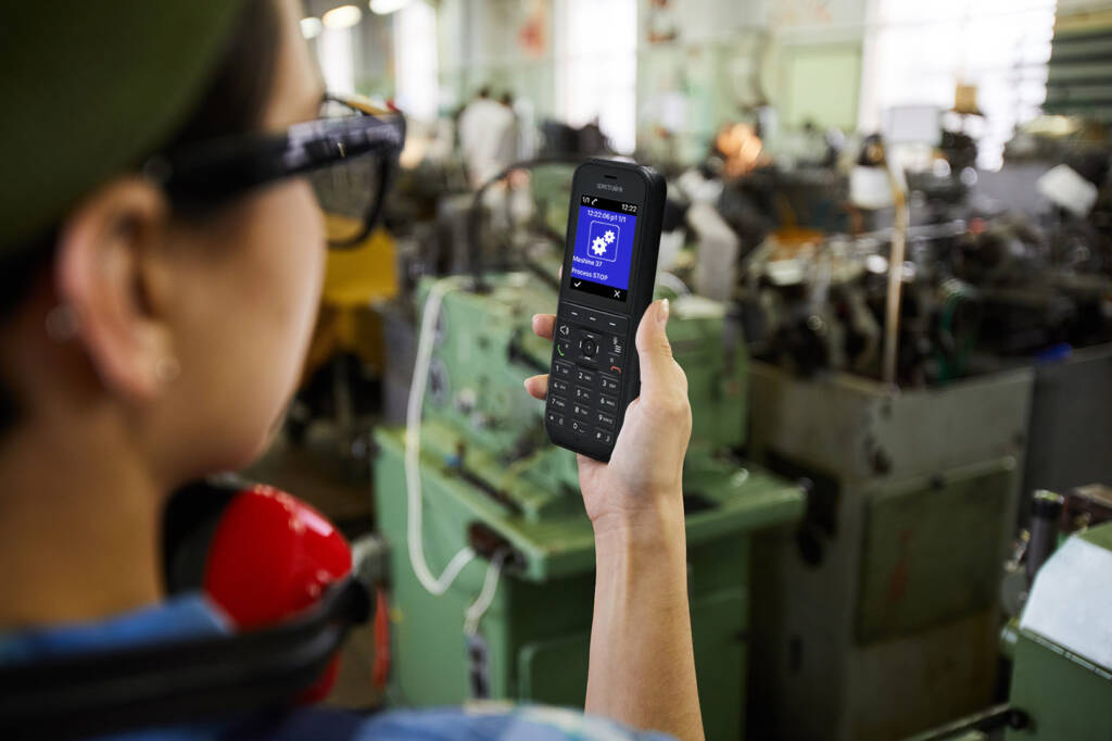 female worker using MS Teams app on spectralink device on manufacturing floor