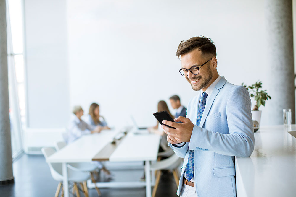 Employee of hotel looks at Spectralink phone