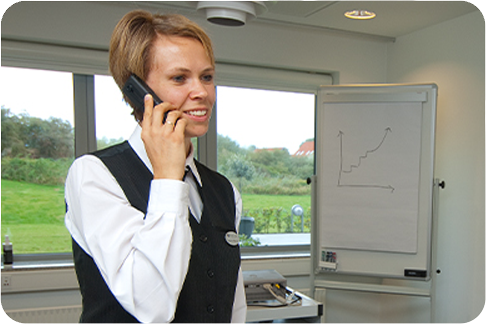 Caterer talking on cell phone in conference room