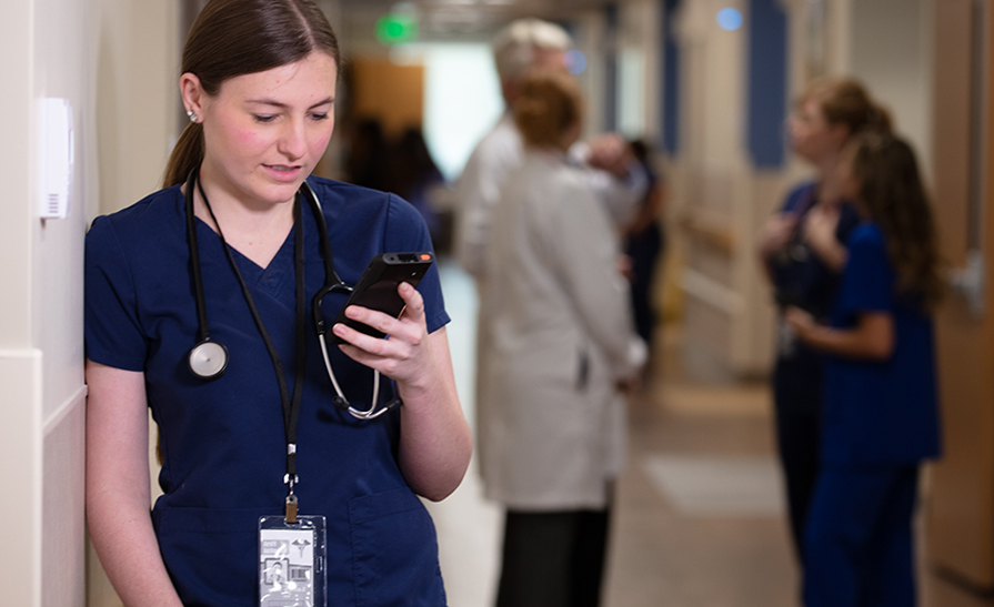 Nurse using phone to check email