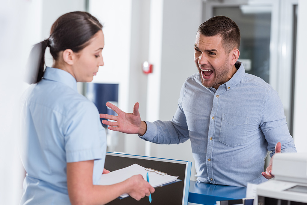 Angry customer gestures and yells at hospital employee