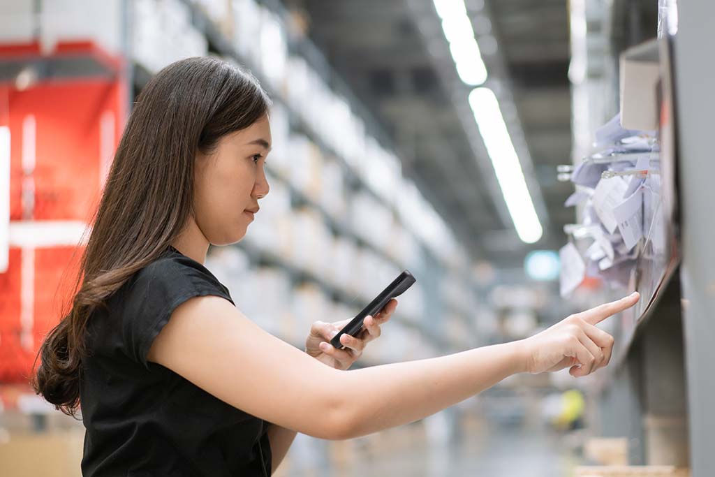 Retail Worker With Versity Smart Phone